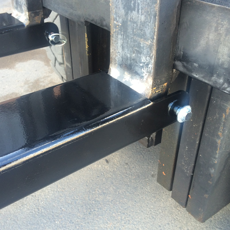 Fork lift extension sleeve lynch pin