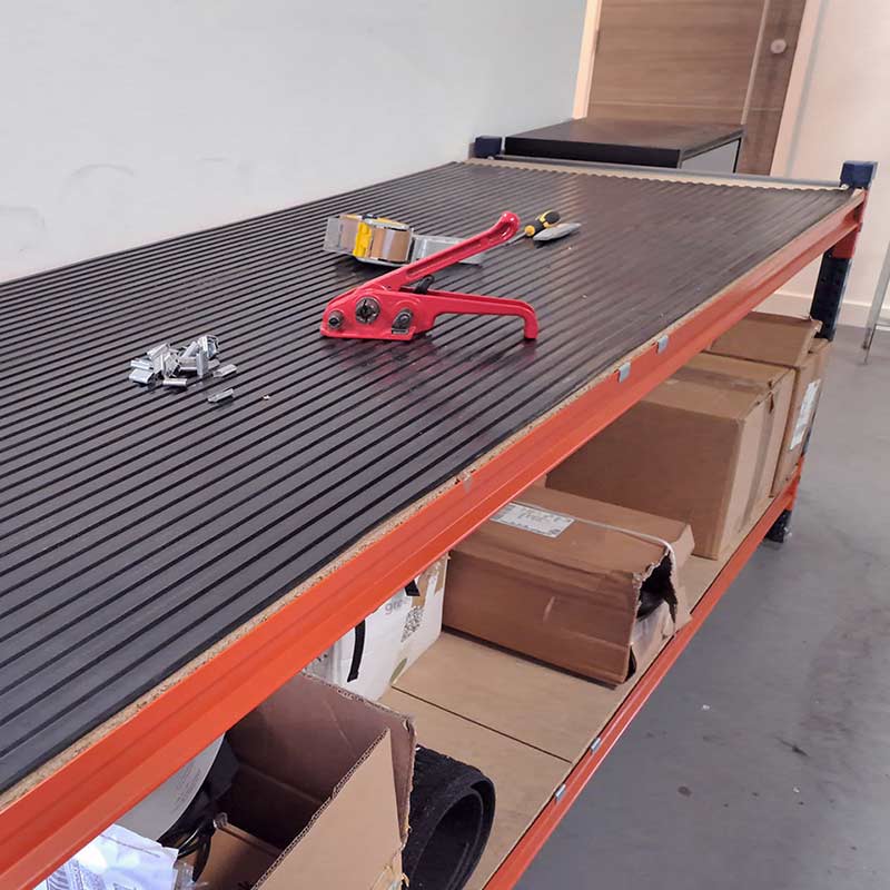 Wide rib black rubber mat roll used as workbench surface