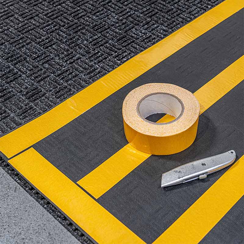 Forklift mat secured with floor tape