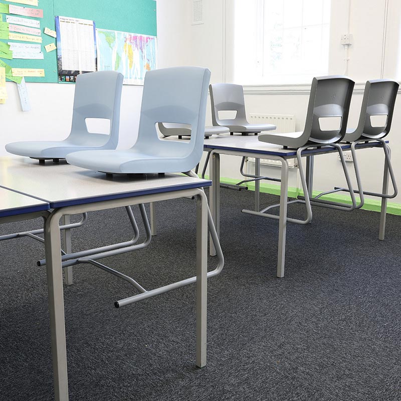 Postura+ reverse cantilever school chairs store neatly on desks to allow for cleaning